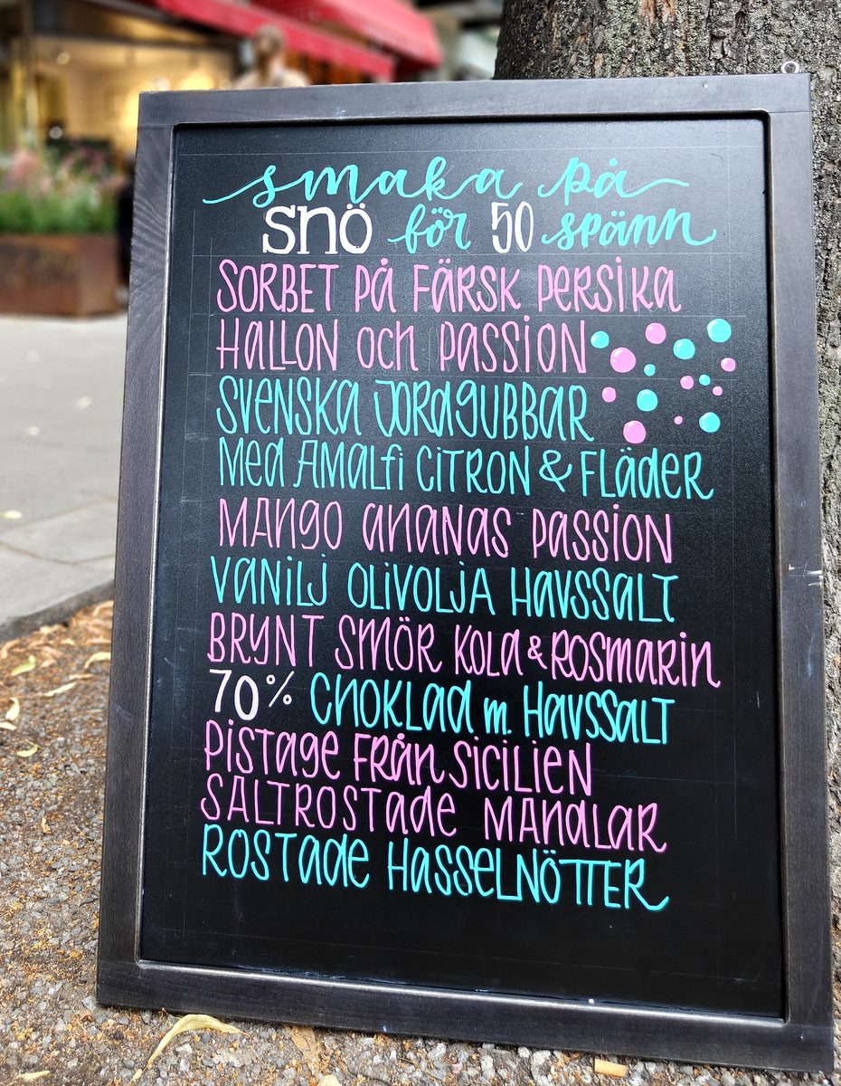 Hand-lettered pavement sign listing sorbet flavours