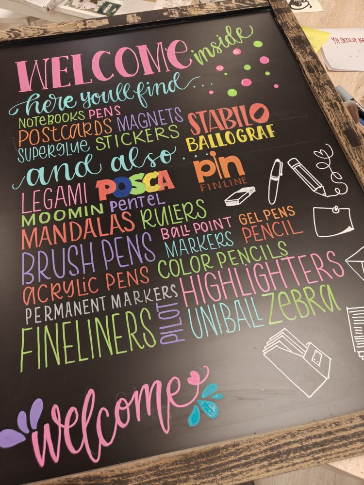 Colourful Welcome lettering and art-supply names on a blackboard