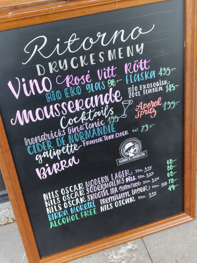 Ritorno drinks menu in white pink and turquoise hand lettering