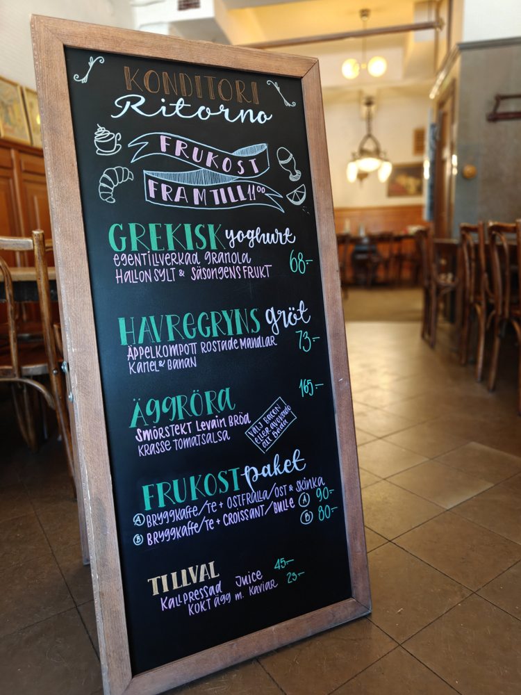 Tall Ritorno breakfast menu board displayed inside a café